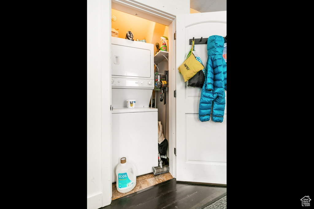 Laundry area with stacked washer and clothes dryer