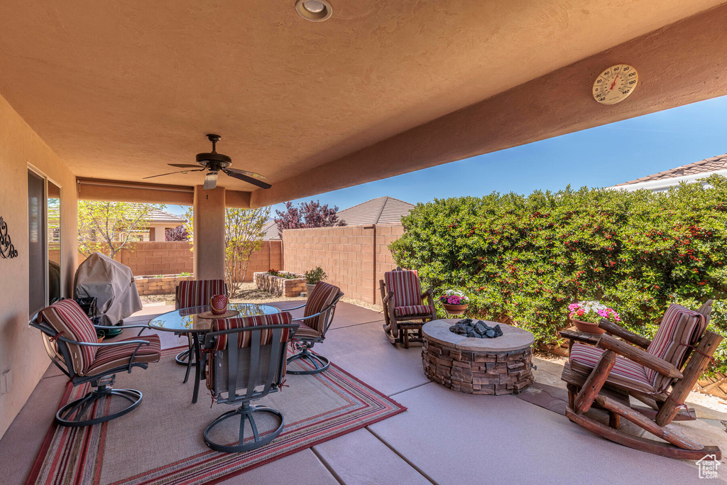 View of terrace featuring an outdoor fire pit and ceiling fan
