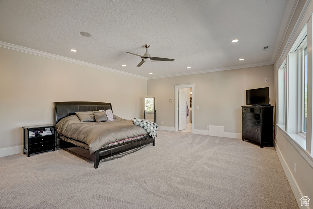 Bedroom featuring crown molding, light colored carpet, and ceiling fan