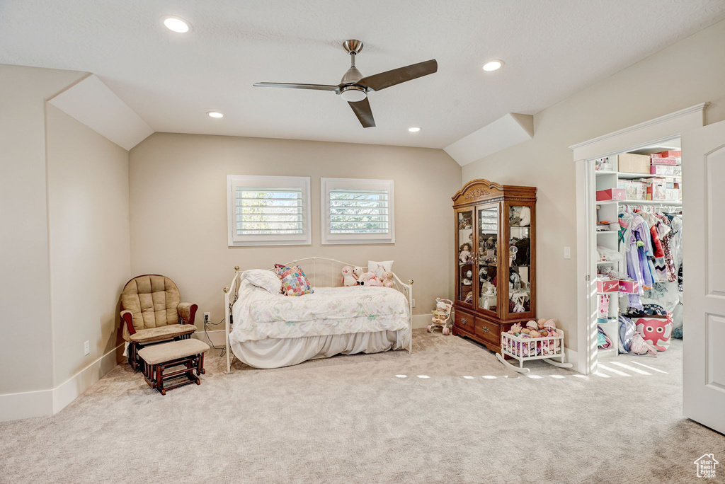 Bedroom featuring light carpet, vaulted ceiling, and ceiling fan