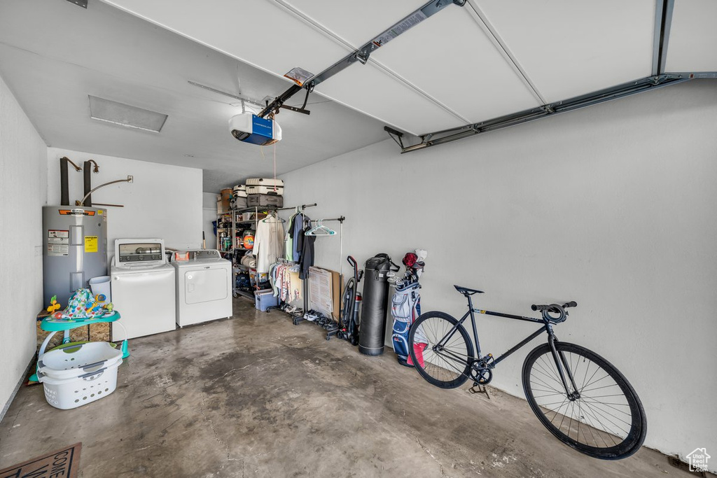 Garage with water heater, washing machine and dryer, and a garage door opener