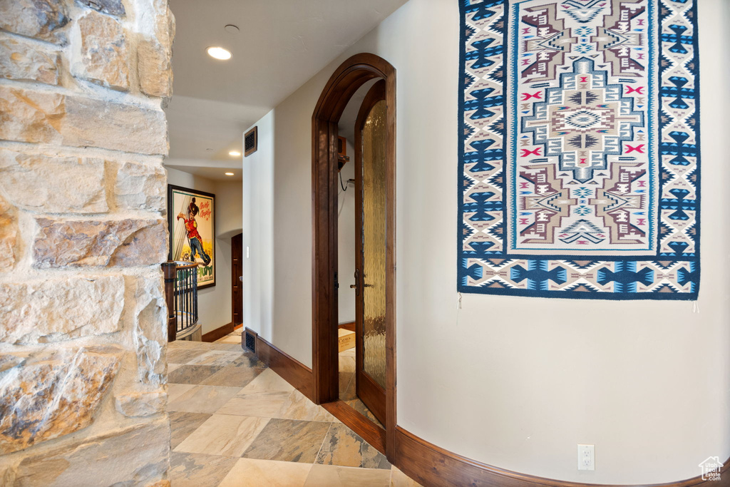 Corridor featuring tile floors