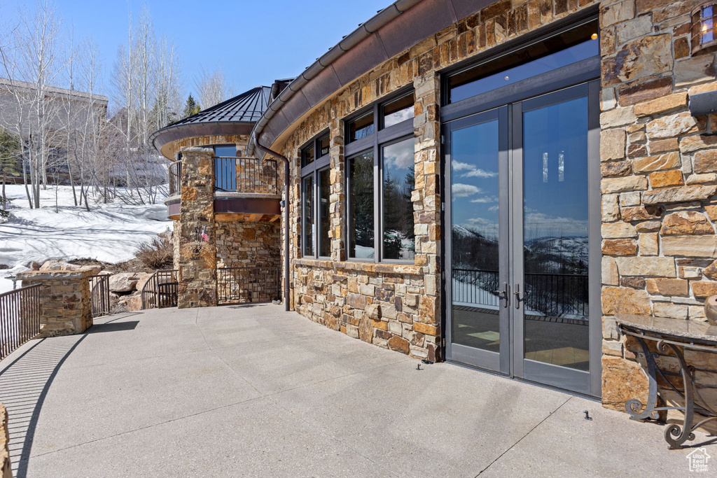 Snow covered patio with french doors