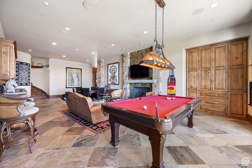 Playroom with light tile floors, a fireplace, and pool table