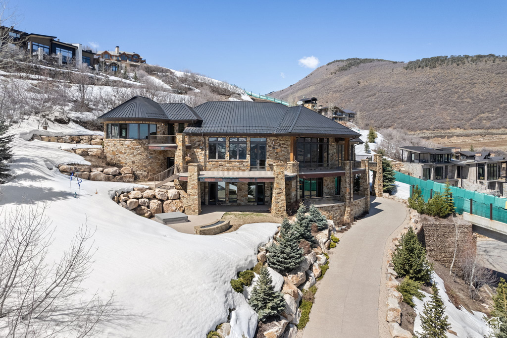 Snow covered property featuring a mountain view