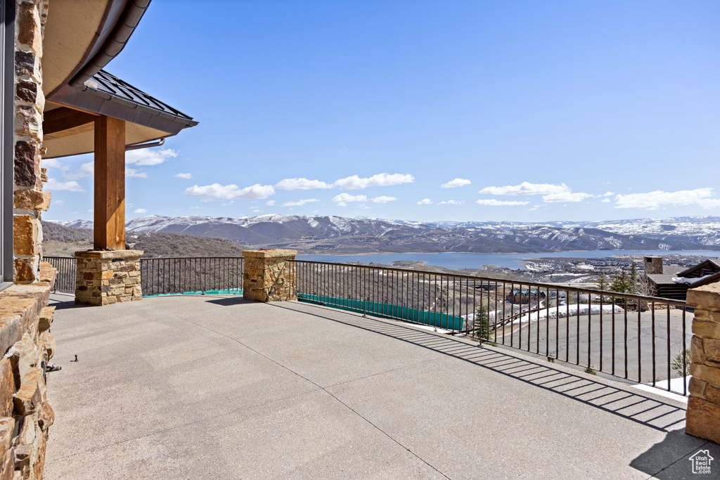 View of patio featuring a water and mountain view