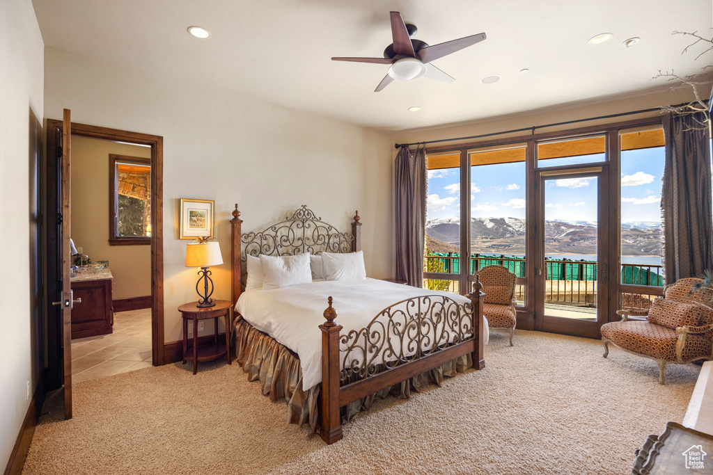 Carpeted bedroom with a mountain view, ceiling fan, and access to exterior