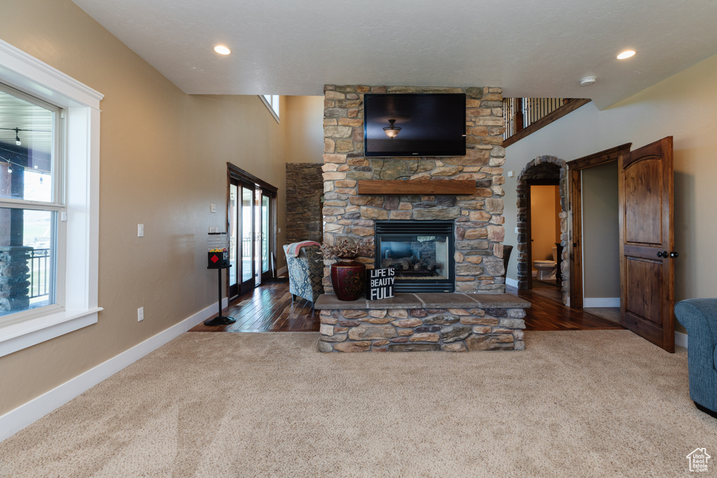 Carpeted living room featuring a wealth of natural light and a fireplace