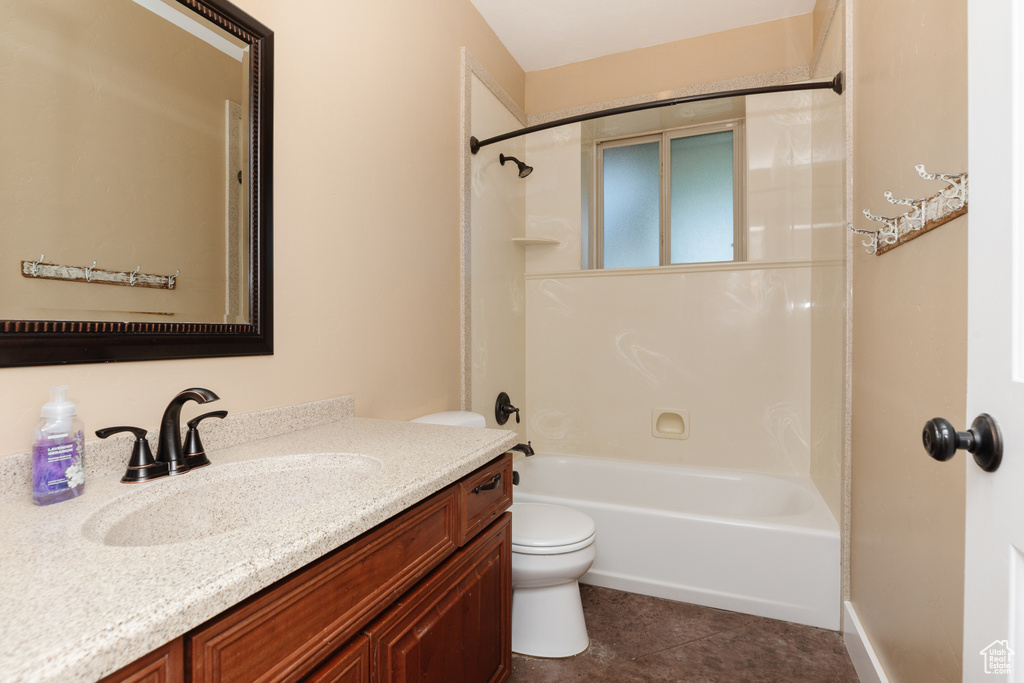 Full bathroom with tile flooring, washtub / shower combination, vanity, and toilet