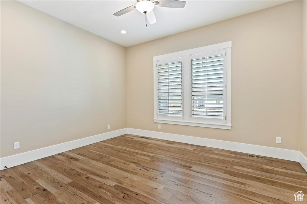 Spare room with light hardwood / wood-style flooring and ceiling fan