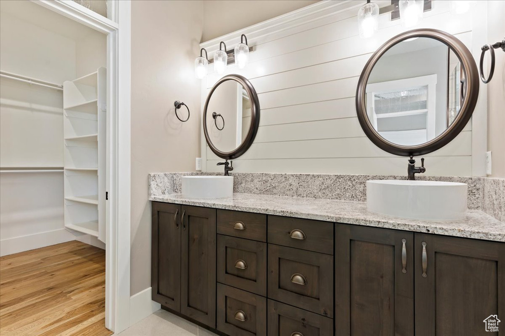 Bathroom featuring wood-type flooring and dual vanity