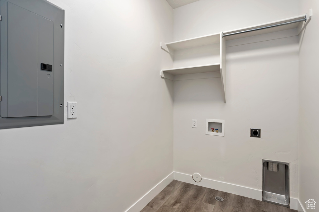 Laundry area with hookup for a gas dryer, washer hookup, hookup for an electric dryer, and dark hardwood / wood-style floors