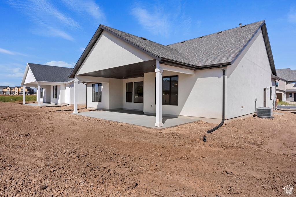 Rear view of house featuring a patio and central AC