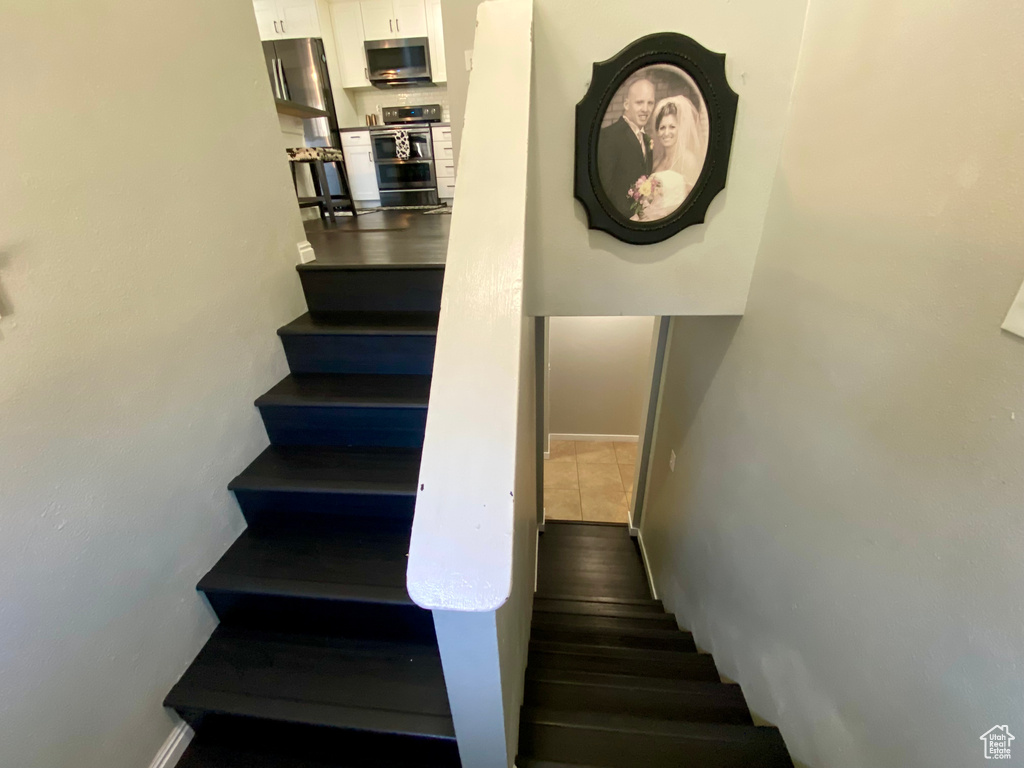 Stairs with dark tile floors