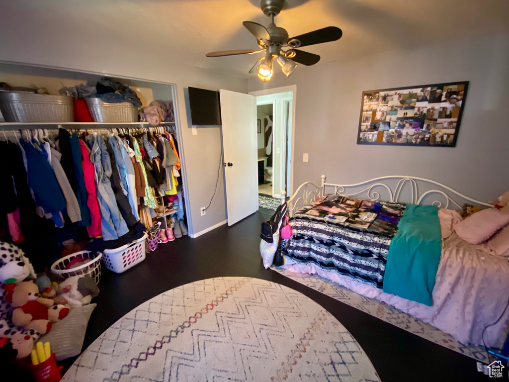Bedroom with ceiling fan and a closet