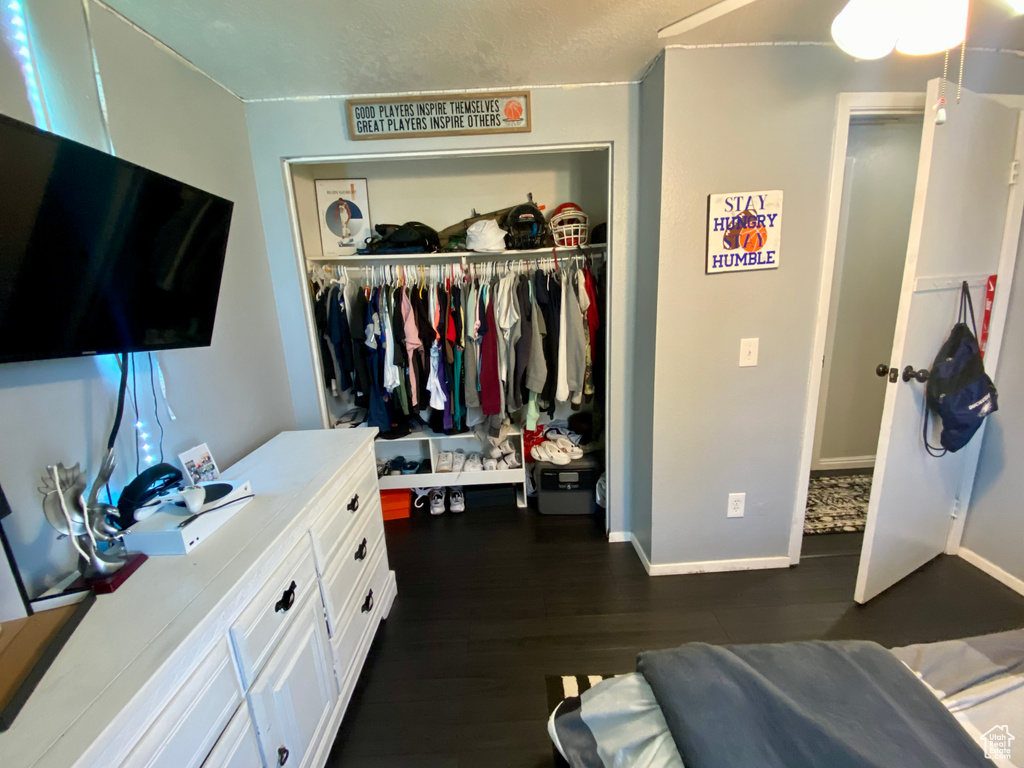 Bedroom featuring a closet and dark wood-type flooring