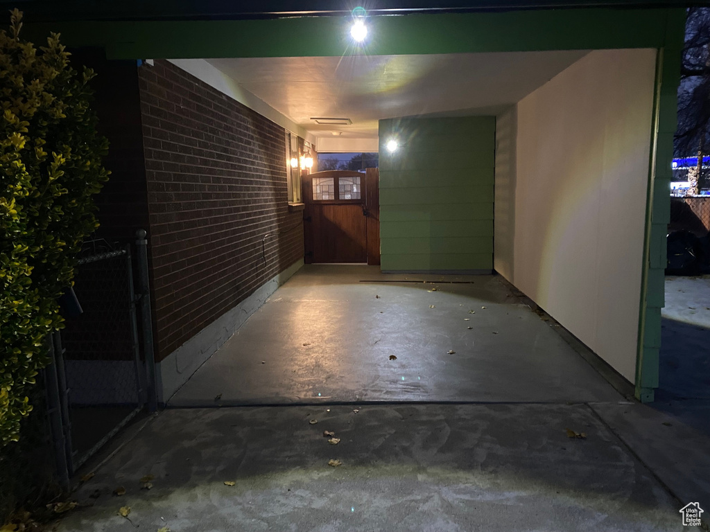 Exterior entry at night featuring a carport