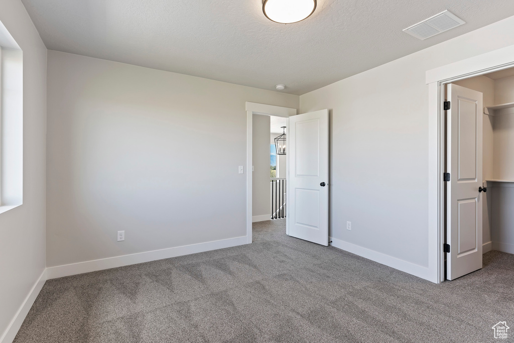 Unfurnished bedroom with light colored carpet