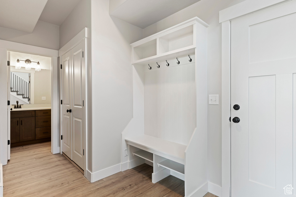 Mudroom with sink and light hardwood / wood-style floors