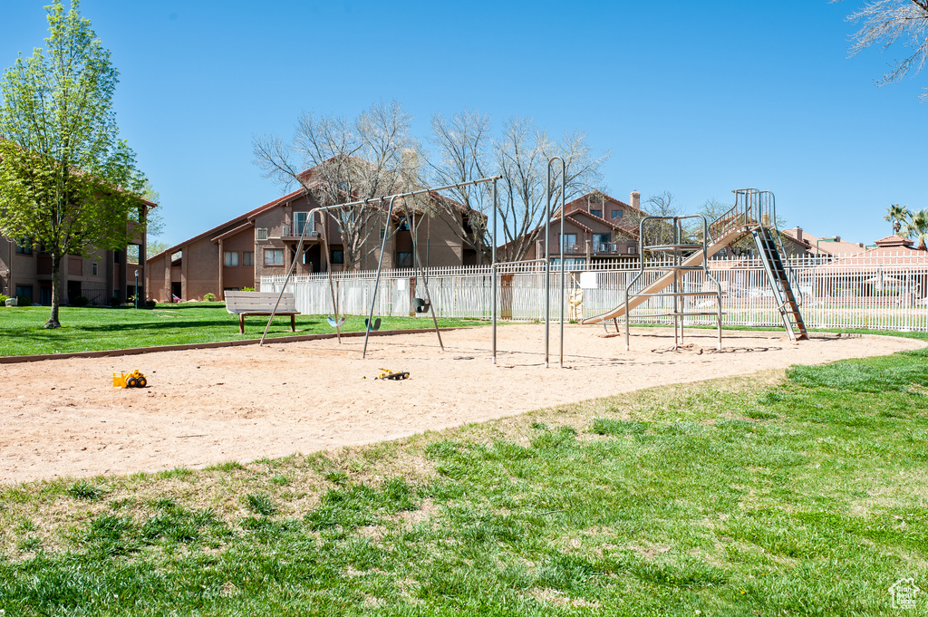 View of home\'s community featuring a lawn and a playground
