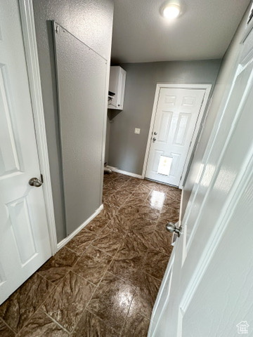 Corridor with dark tile floors
