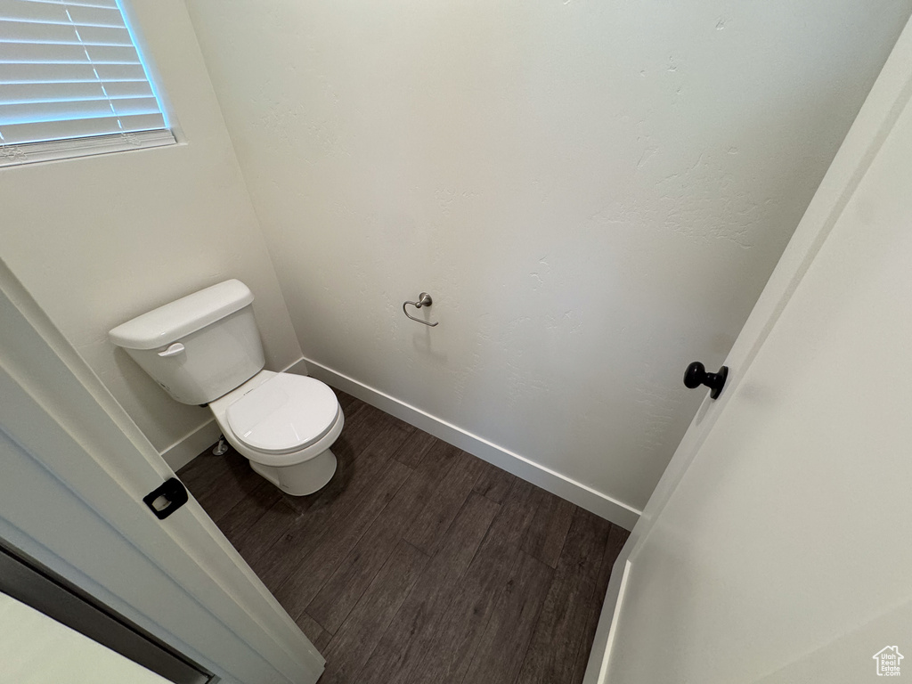 Bathroom featuring wood-type flooring and toilet