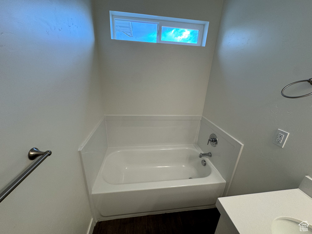 Bathroom featuring wood-type flooring and a bathing tub