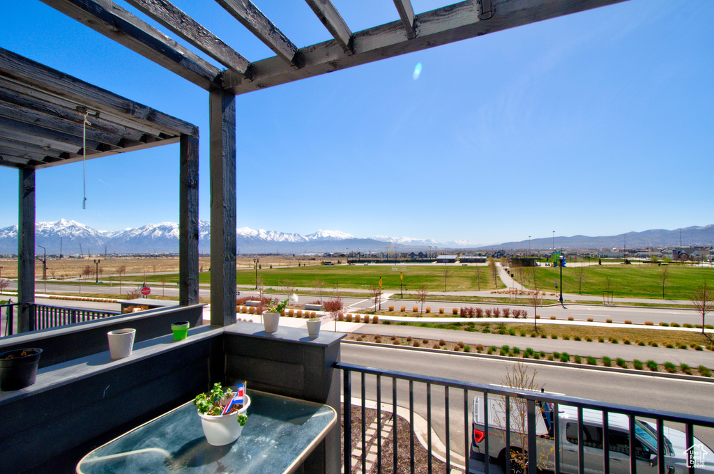 Balcony featuring a mountain view and a pergola