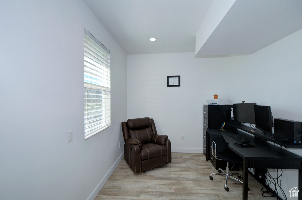 Office with light hardwood / wood-style flooring