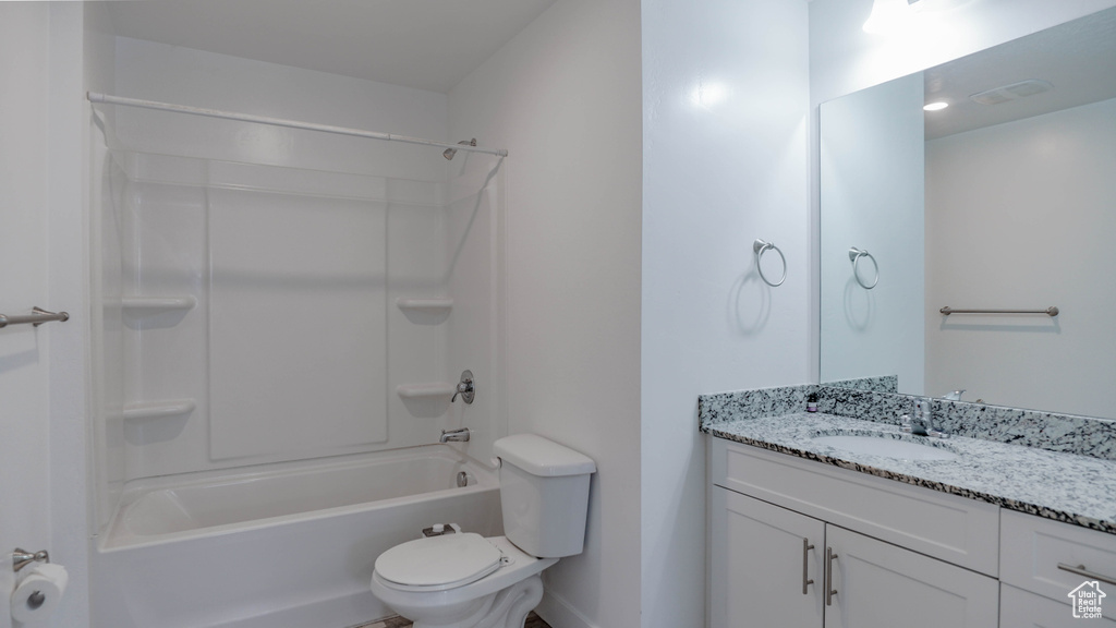 Full bathroom with oversized vanity, toilet, and shower / washtub combination