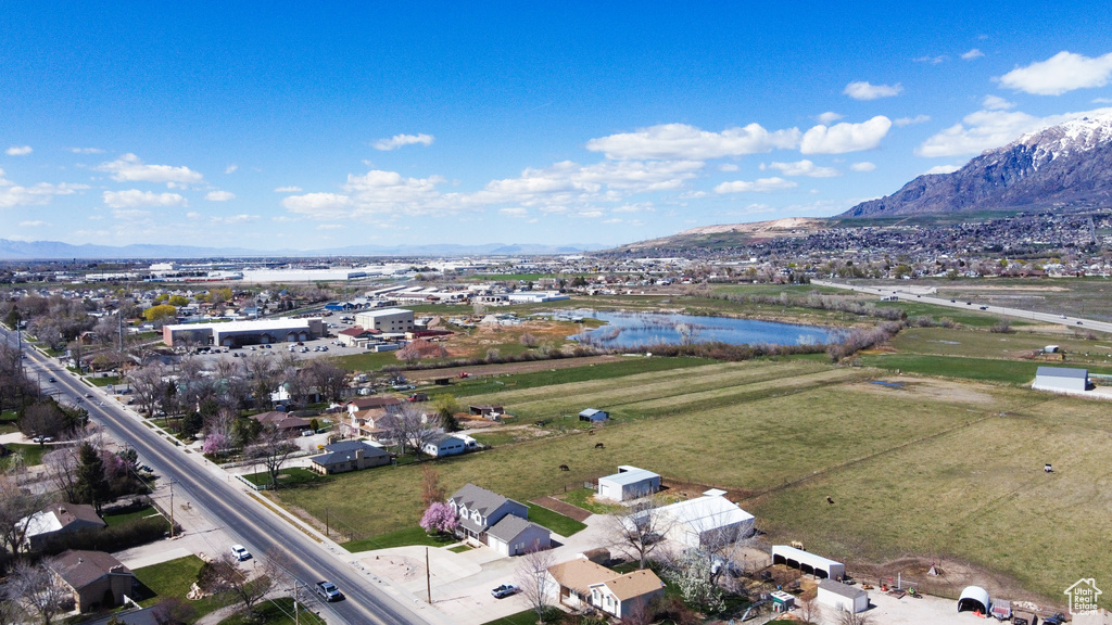 Birds eye view of property featuring a water and mountain view