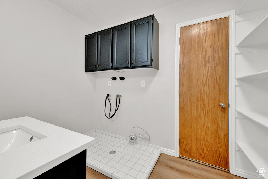 Bathroom with wood-type flooring, a shower, and vanity
