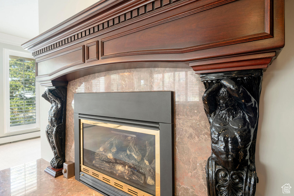 Details with ornamental molding, a baseboard heating unit, and tile floors