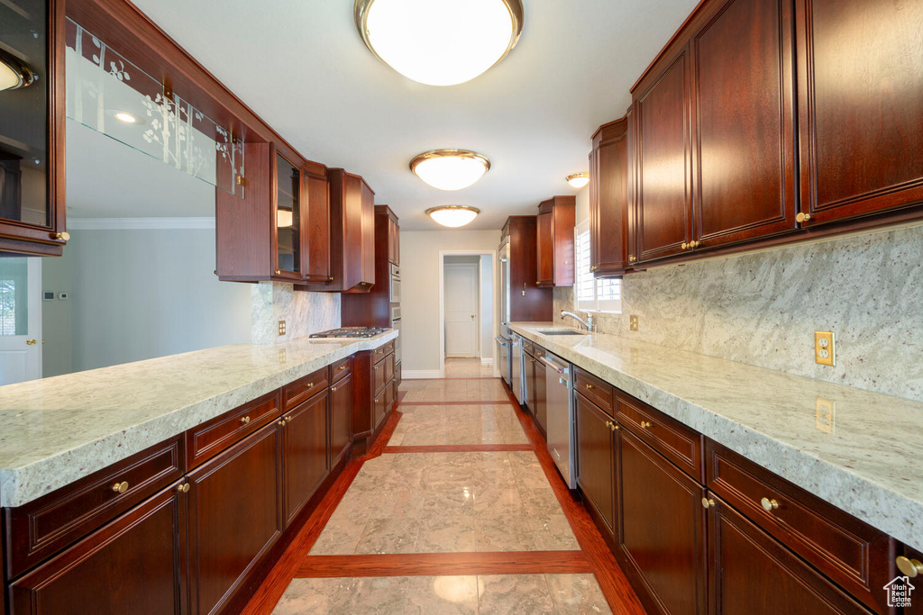 Kitchen with tasteful backsplash, light tile floors, and ornamental molding