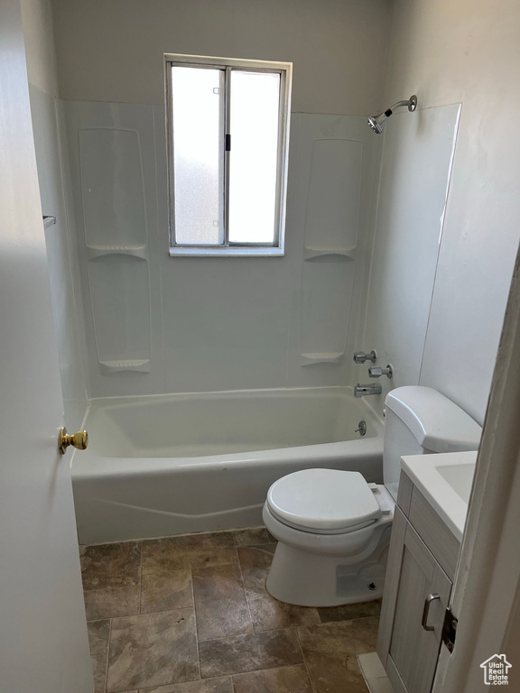 Full bathroom with tile floors, shower / bathing tub combination, vanity, and toilet