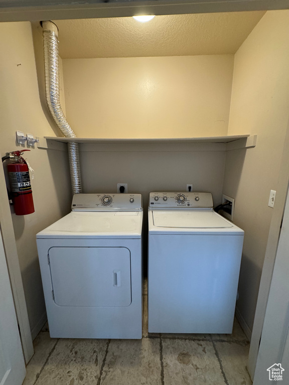 Laundry room featuring washer hookup, hookup for an electric dryer, and washing machine and dryer