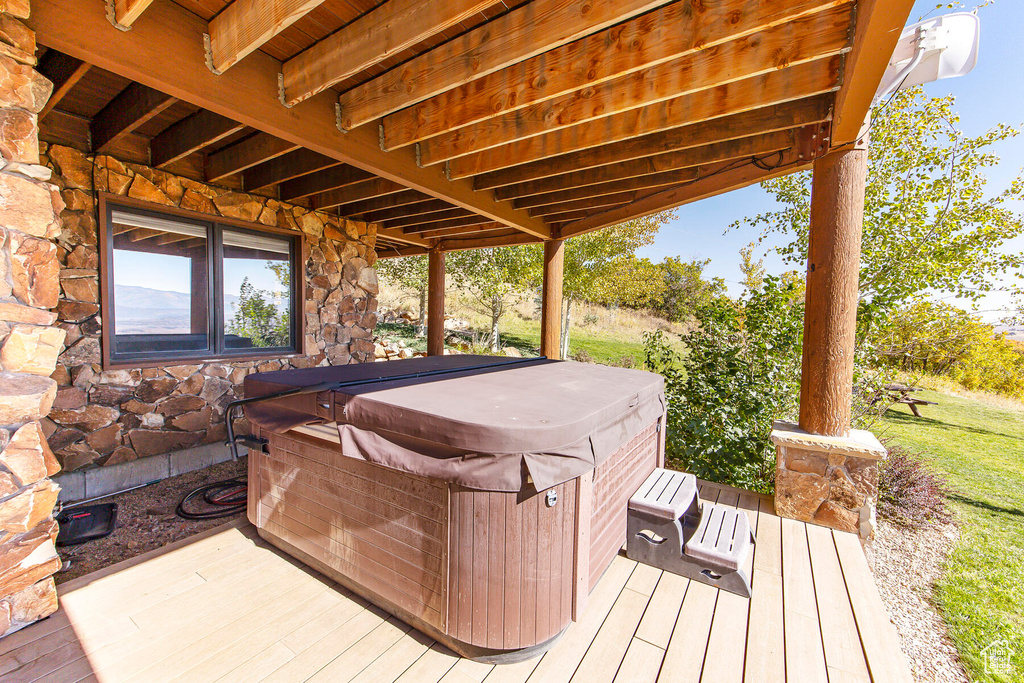 Wooden terrace featuring a hot tub