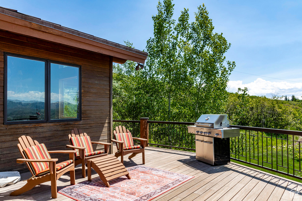 Wooden deck featuring area for grilling