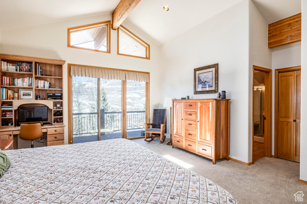 Carpeted bedroom featuring high vaulted ceiling, beam ceiling, and access to outside