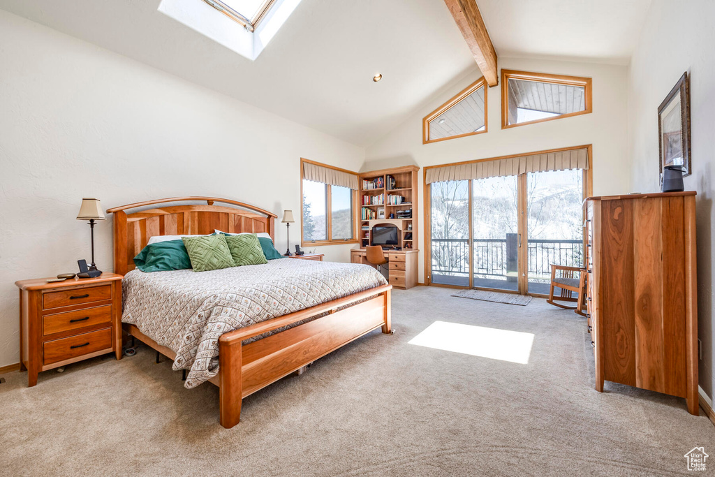 Bedroom featuring high vaulted ceiling, access to outside, beam ceiling, light carpet, and a skylight