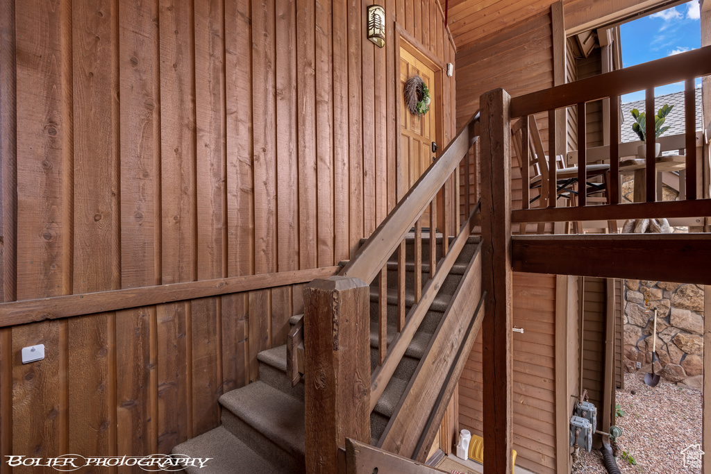 Stairs featuring wooden walls