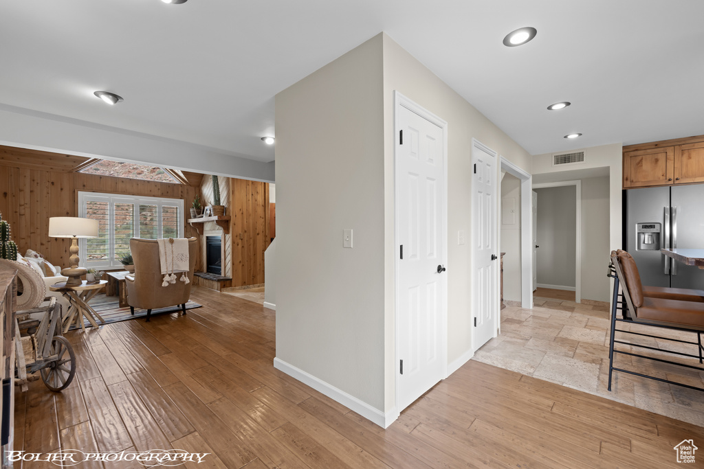 Interior space with wooden walls and light tile floors