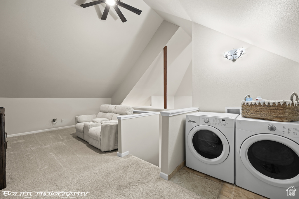 Laundry area featuring light carpet, ceiling fan, and separate washer and dryer