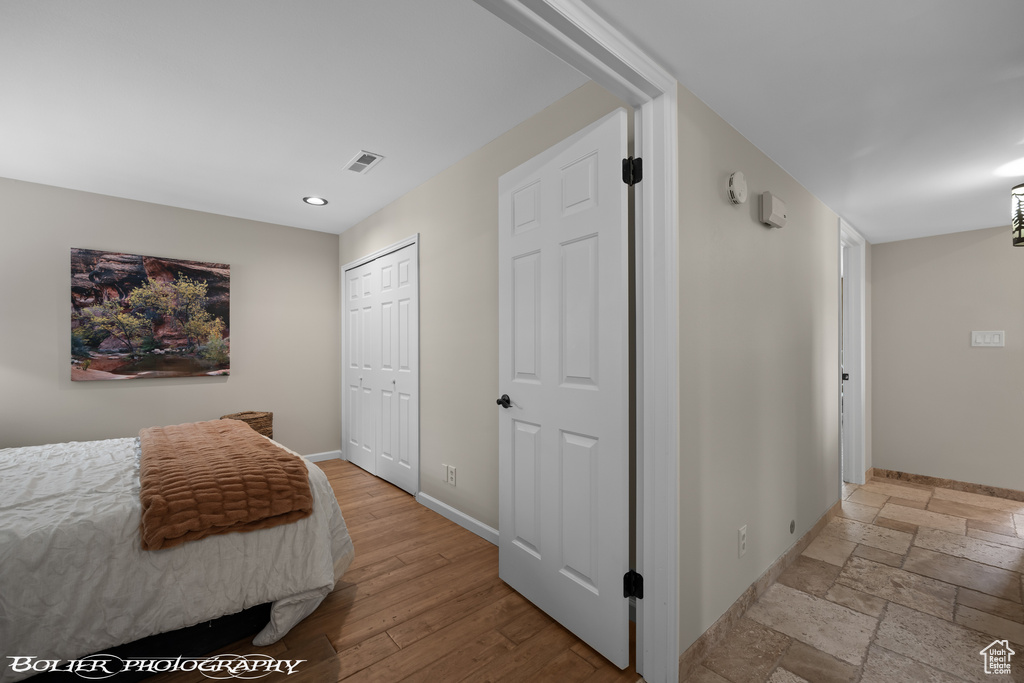 Bedroom featuring a closet and light tile floors