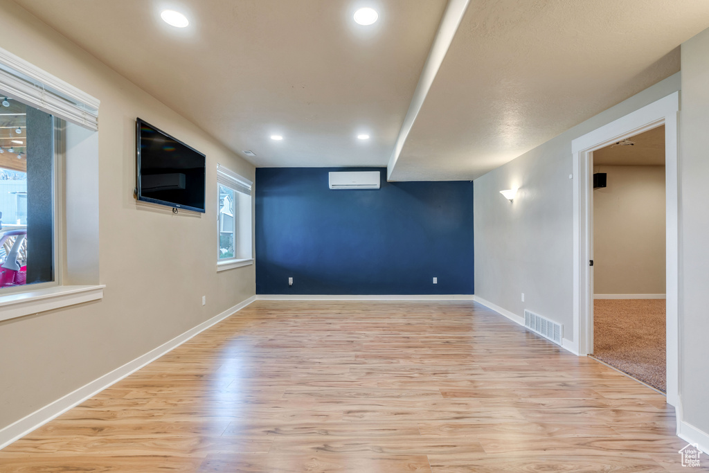Spare room featuring light hardwood / wood-style floors and a wall mounted air conditioner