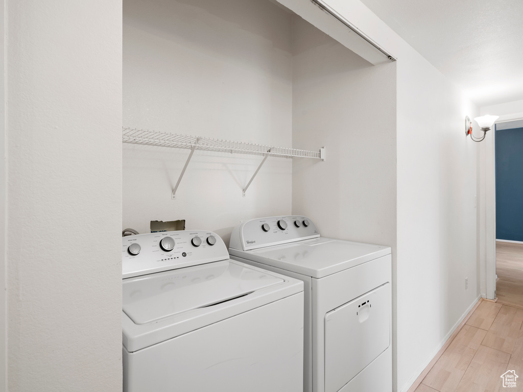 Laundry room featuring light hardwood / wood-style flooring and separate washer and dryer