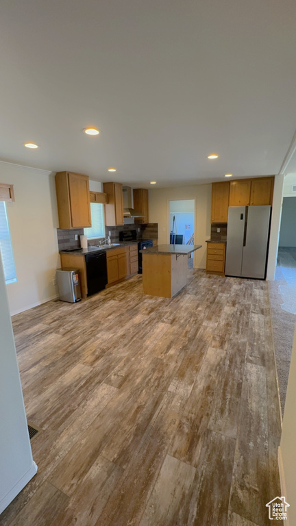 Kitchen with stainless steel refrigerator, light hardwood / wood-style floors, dishwasher, and range