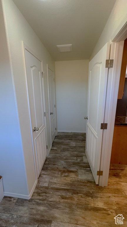 Corridor with light hardwood / wood-style flooring