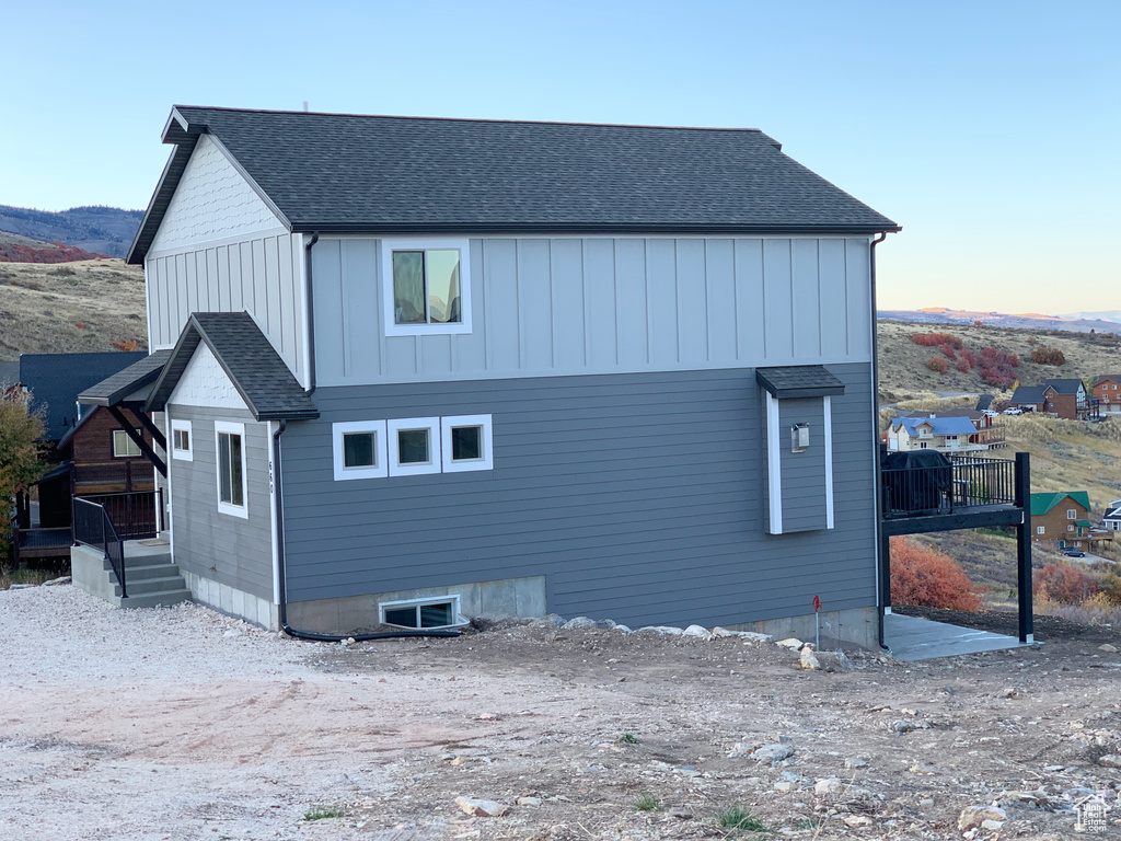 Property exterior at dusk featuring a deck