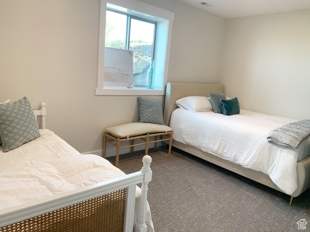 Bedroom featuring dark carpet